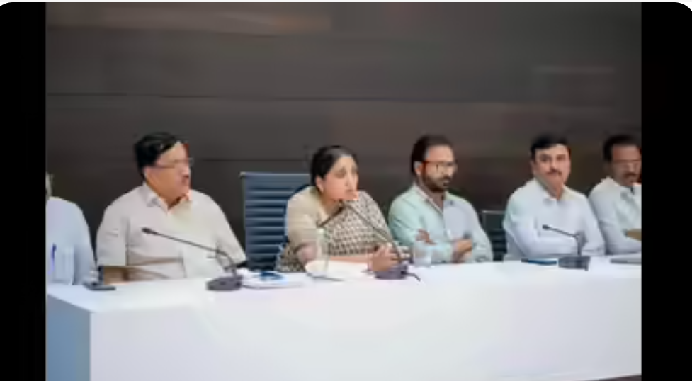 “Sunetra Pawar at a press podium during a Nationalist Congress Party leadership announcement event.”